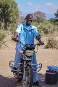 African man smiling on motorcycle