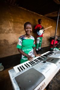 Young African girl playing keyboard