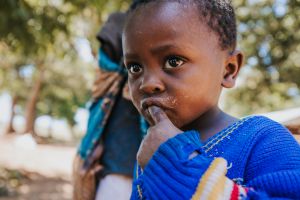 Little African boy with finger in his mouth