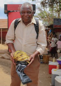 Old African man with bananas