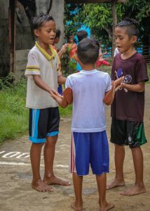 Three young Asian boys holding hands