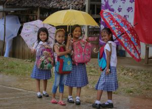 Four young asian girls with umbrellas