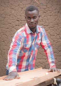 Young African man doing woodwork