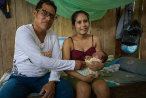 Community health worker with young Latin American mother and baby