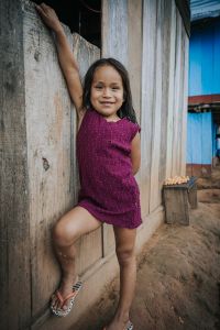Little Latin American girl standing and posing