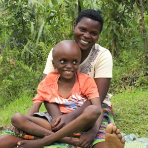 African mother sitting with disabled child